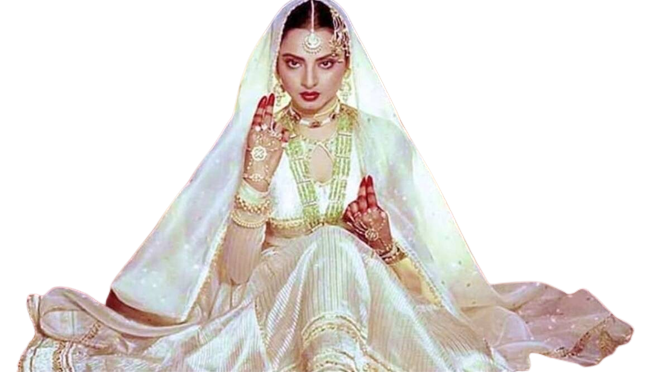 An Indian women with a front pose, wearing a white dress with her head covered and gold jewelry.